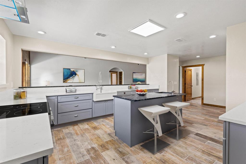 516 County Road Honey Grove, TX 75446 - Photo 12 of 27 a kitchen with stainless steel appliances kitchen island granite countertop a sink and cabinets
