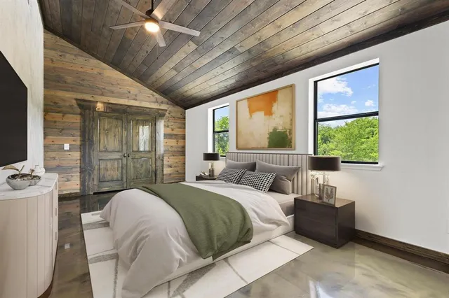 a bedroom with a large bed and a large window