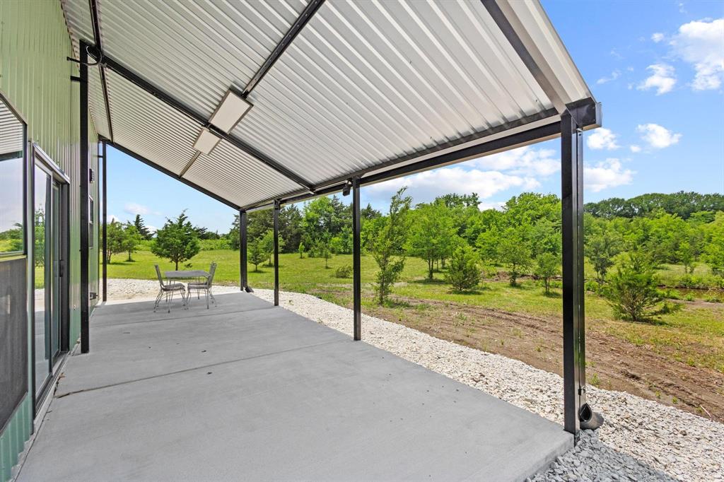 516 County Road Honey Grove, TX 75446 - Photo 20 of 27 a view of a room with porch and wooden floor