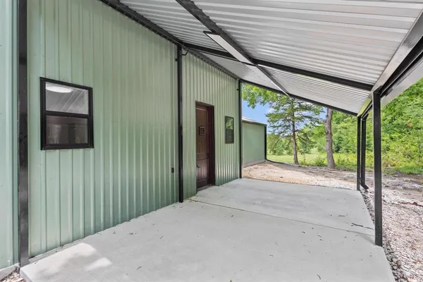 a view of a porch with a table and chairs