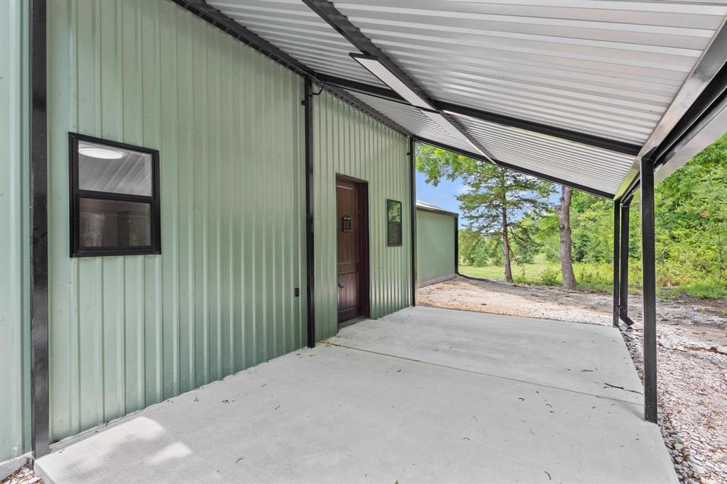 516 County Road Honey Grove, TX 75446 - Photo 21 of 27 a view of a porch with a table and chairs
