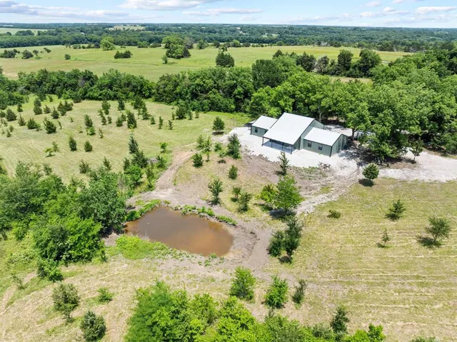 an aerial view of a house with a yard