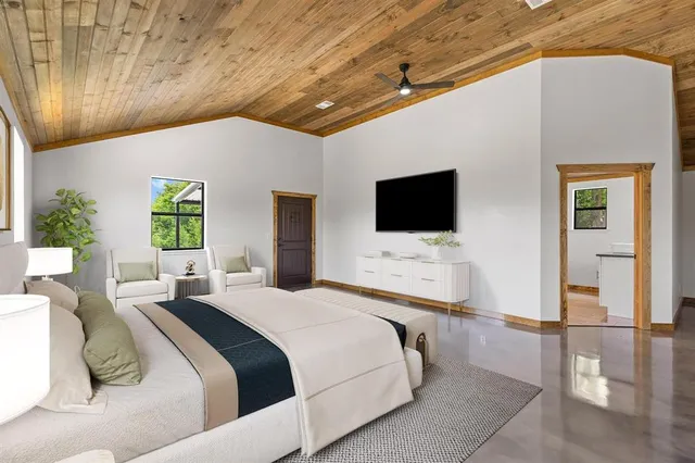 a bedroom with a bed and a flat screen tv