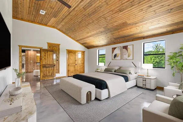 a spacious bedroom with a large bed and a large window