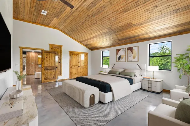 a spacious bedroom with a large bed and a large window