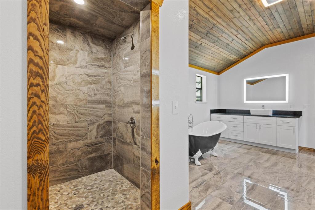 516 County Road Honey Grove, TX 75446 - Photo 7 of 27 a bathroom with a granite countertop sink a toilet and shower