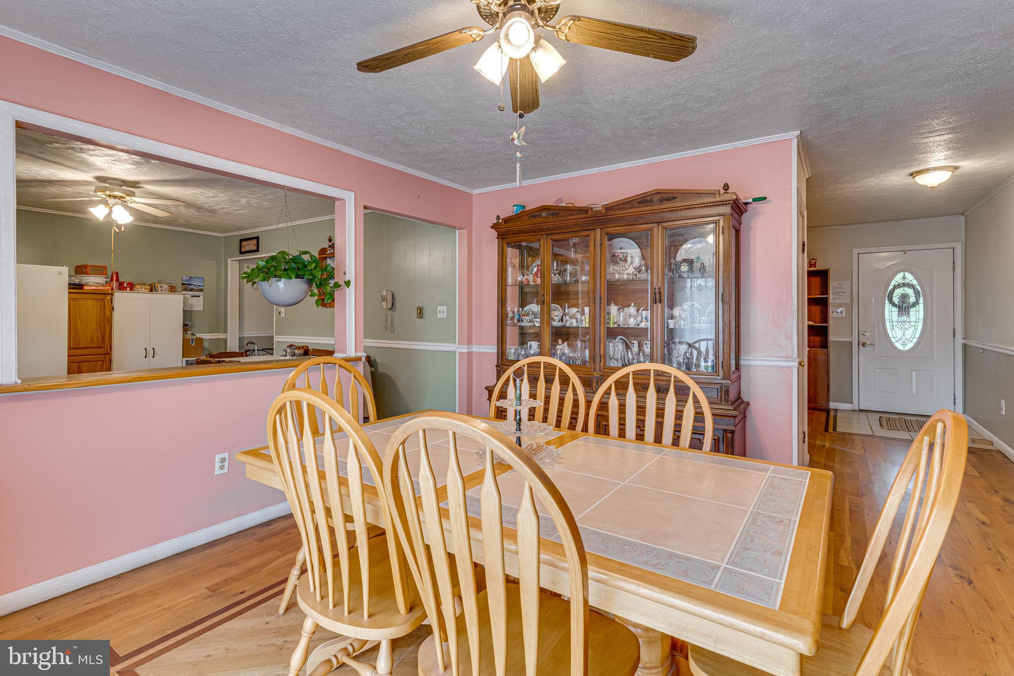 5865 Mackall Road St. Leonard, MD 20685 - Photo 7 of 24 a view of a dining room with furniture wooden floor and chandelier