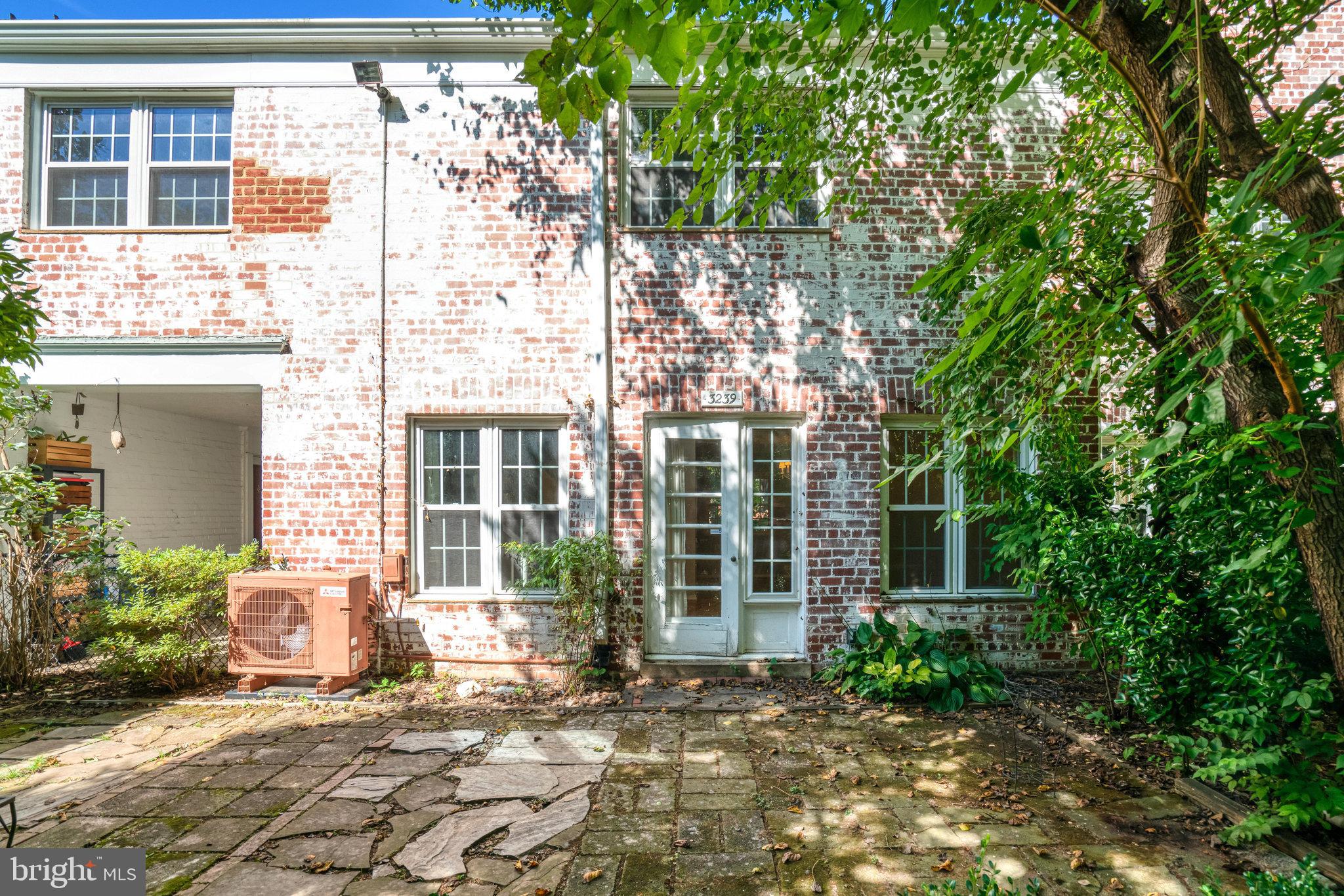 3239 Gunston Road Alexandria, VA 22302 - Photo 20 of 58 a view of a brick house with windows and outdoor space