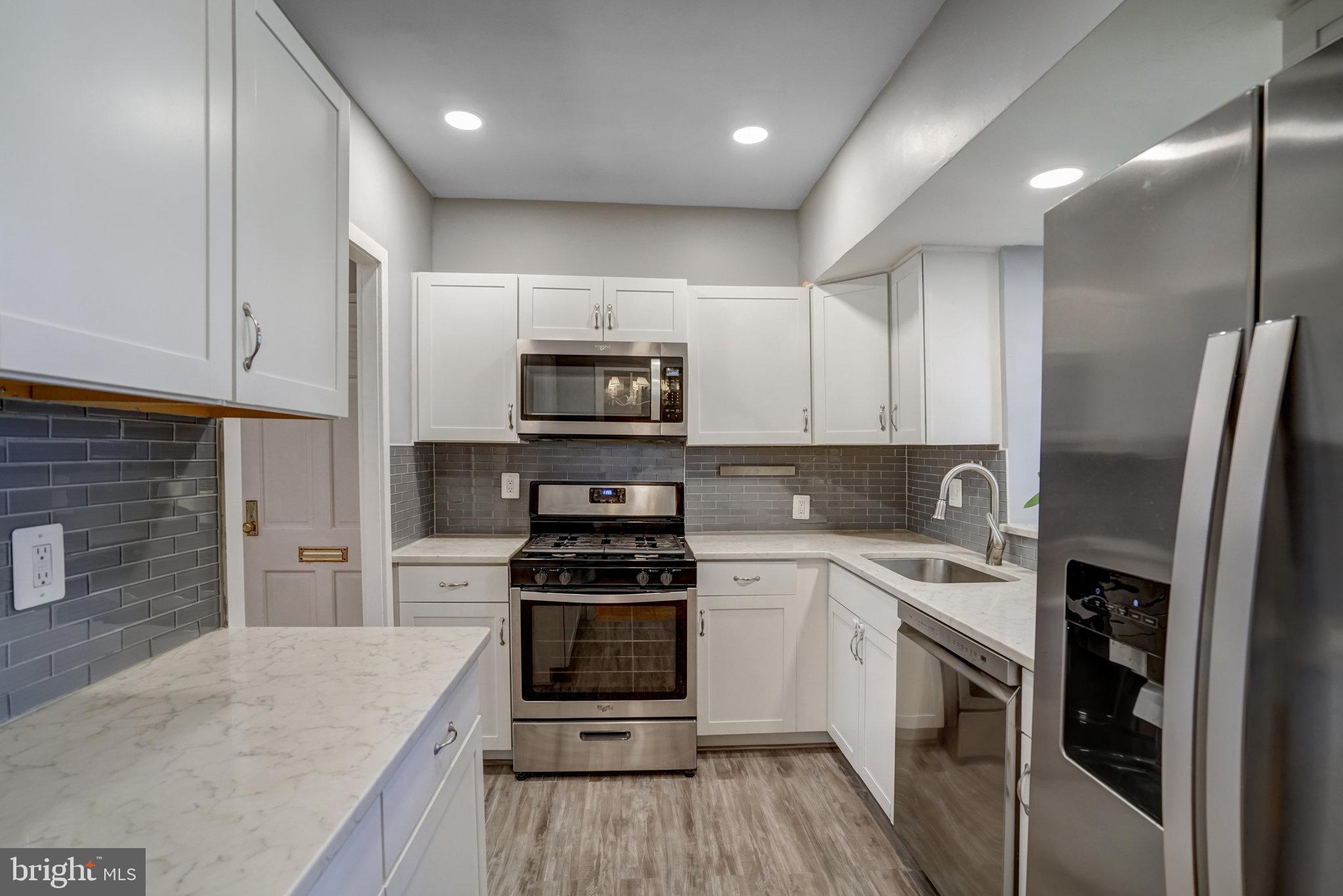 3239 Gunston Road Alexandria, VA 22302 - Photo 7 of 58 a kitchen with a sink a stove and refrigerator