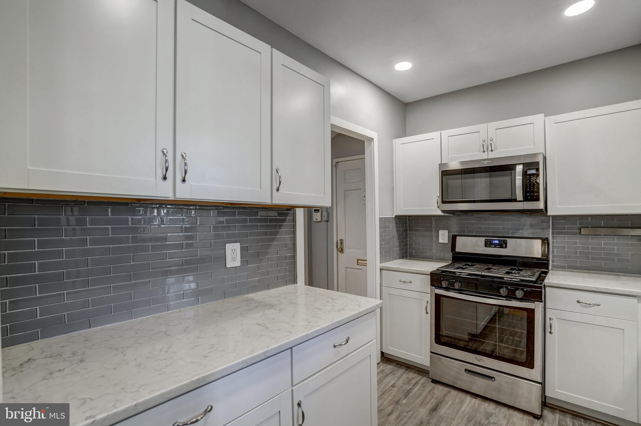3239 Gunston Road Alexandria, VA 22302 - Photo 8 of 58 a kitchen with granite countertop white cabinets and stainless steel appliances