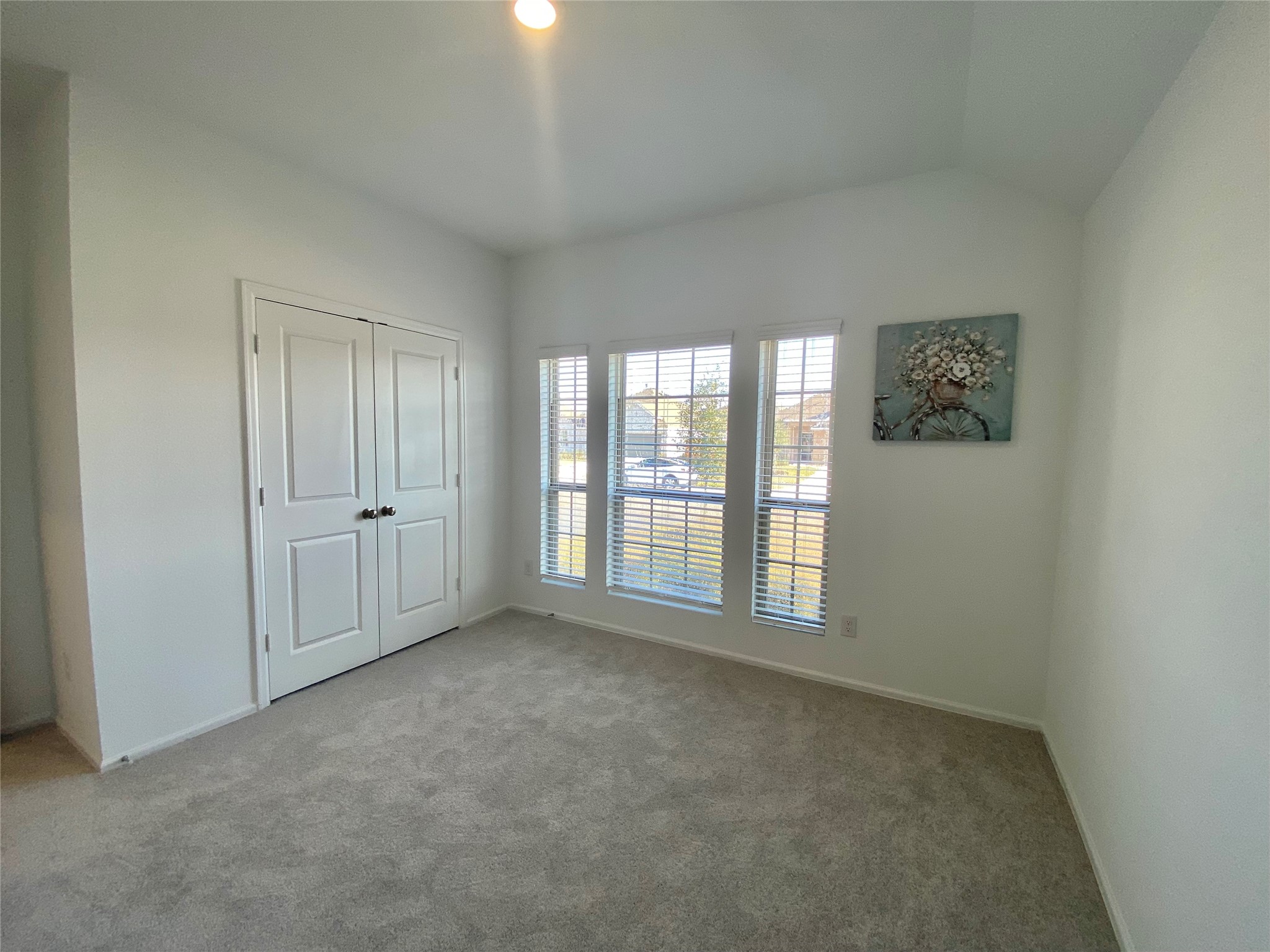 3724 Moss Hl Road Rosenberg, TX 77469 - Photo 20 of 29 Bright, cozy room with soft carpeting, large windows for natural light, and a double-door closet. Perfect for a bedroom or home office.