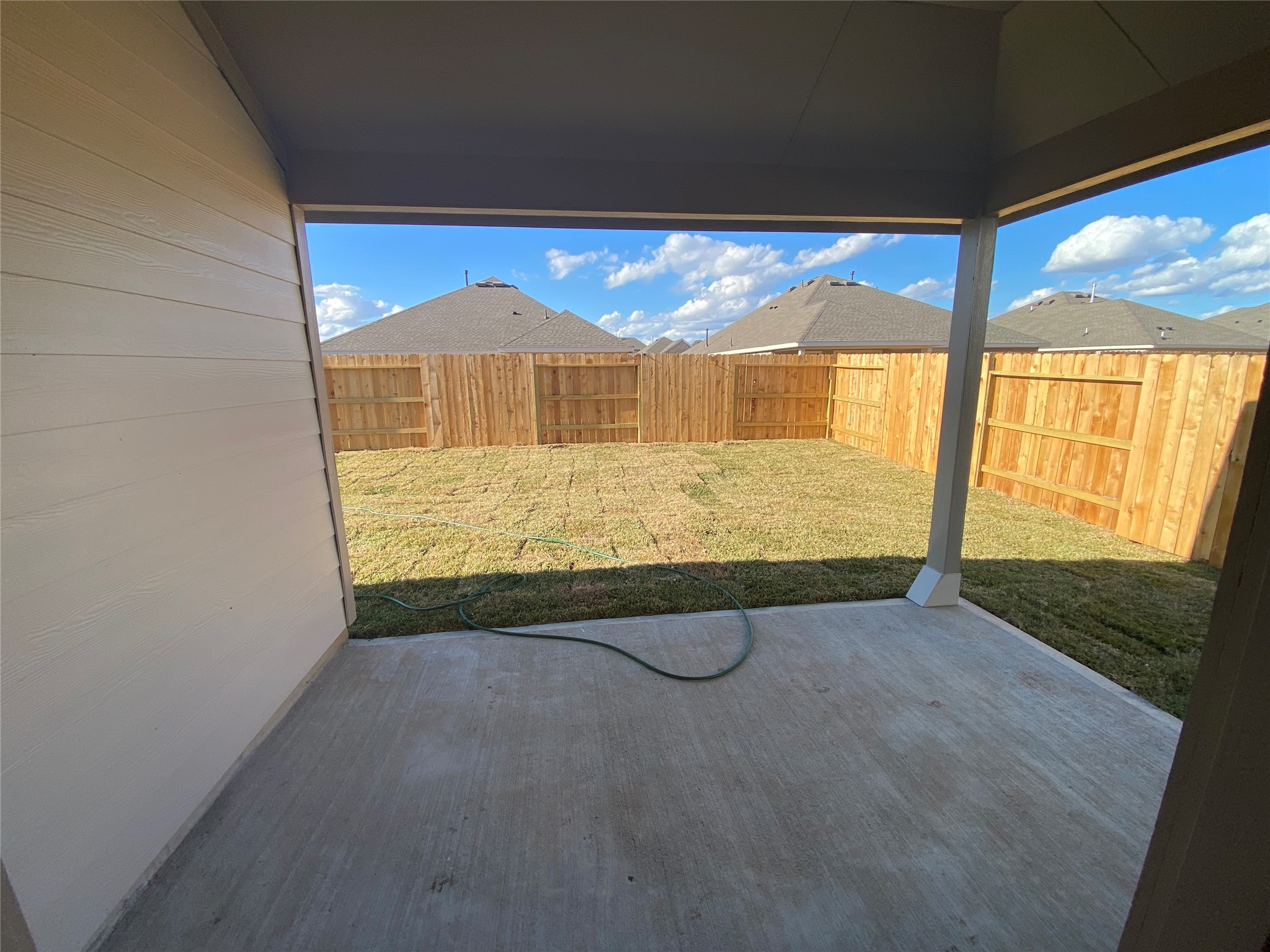 3724 Moss Hl Road Rosenberg, TX 77469 - Photo 27 of 29 A covered patio opens to a fenced backyard with a grassy lawn, ideal for outdoor activities and privacy.