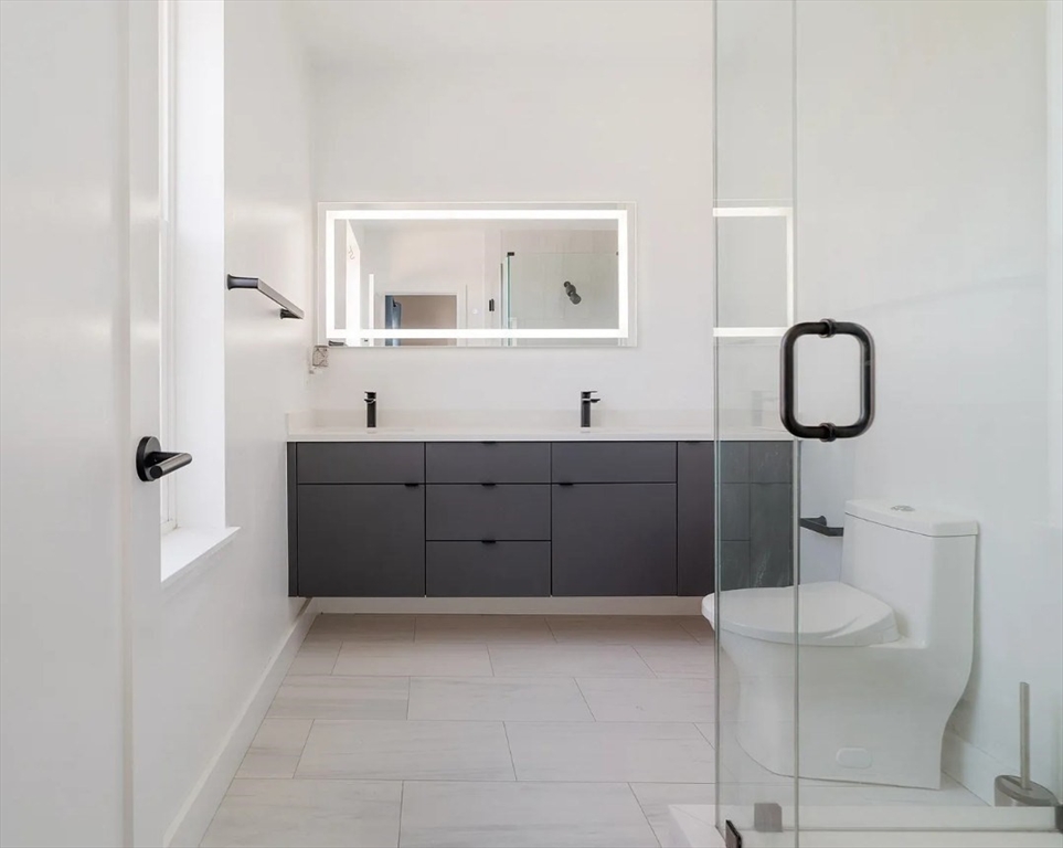 243 Condor Street, Unit 4 Boston, MA 02128 - Photo 10 of 13 a bathroom with a sink a toilet and mirror