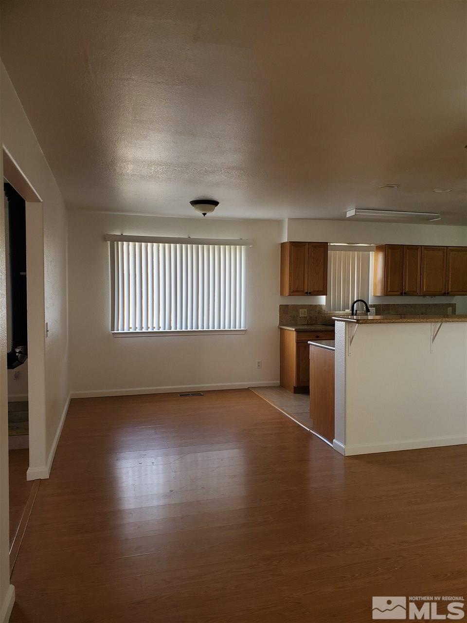 2780 Rice Road Fallon, NV 89406 - Photo 3 of 21 an empty room with wooden floor and windows