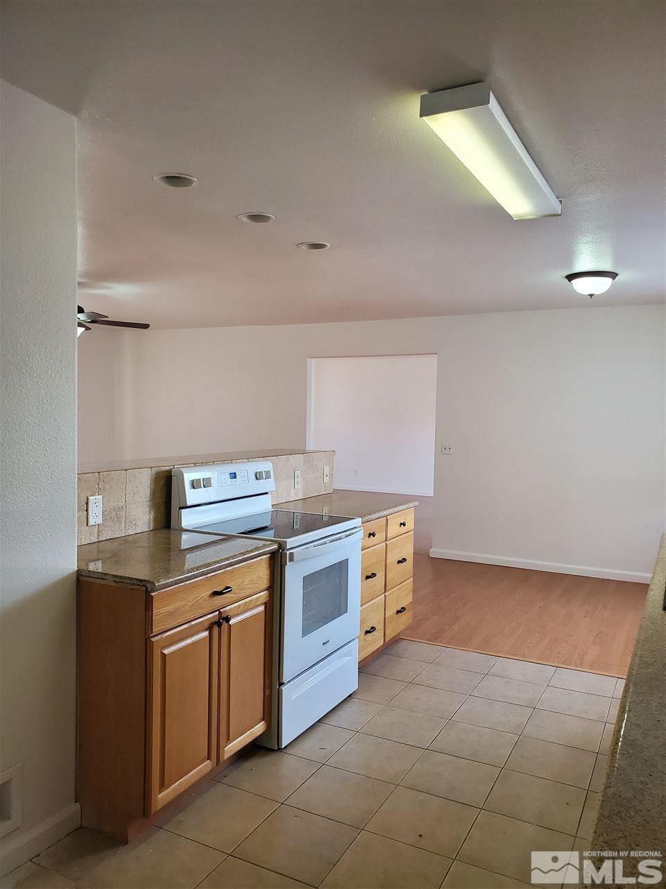 2780 Rice Road Fallon, NV 89406 - Photo 6 of 21 a kitchen with a stove top oven cabinets and a refrigerator