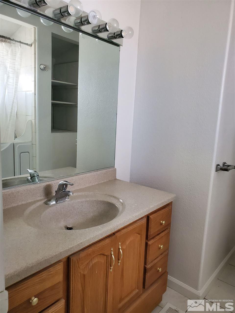 2780 Rice Road Fallon, NV 89406 - Photo 9 of 21 a bathroom with a sink and a mirror