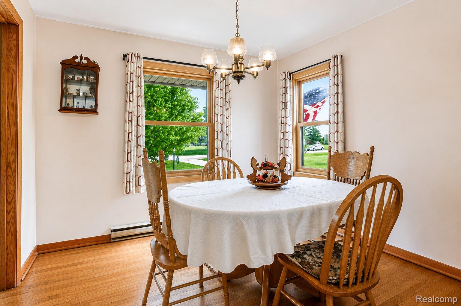 6373 Norman Road Jeddo, MI 48032 - Photo 6 of 32 Dining area with light wood finished floors, hanging lights, and a baseboard heating unit