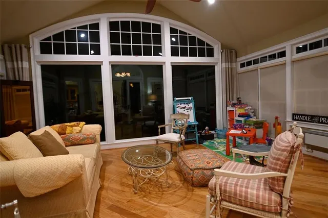 a view of a patio with couches table and chairs and potted plants