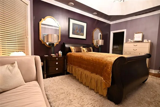 a bedroom with a bed and a dresser