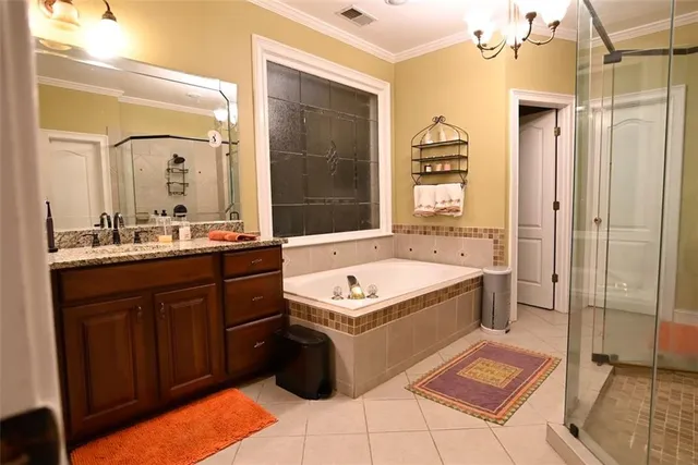 a bathroom with a tub a sink and a mirror