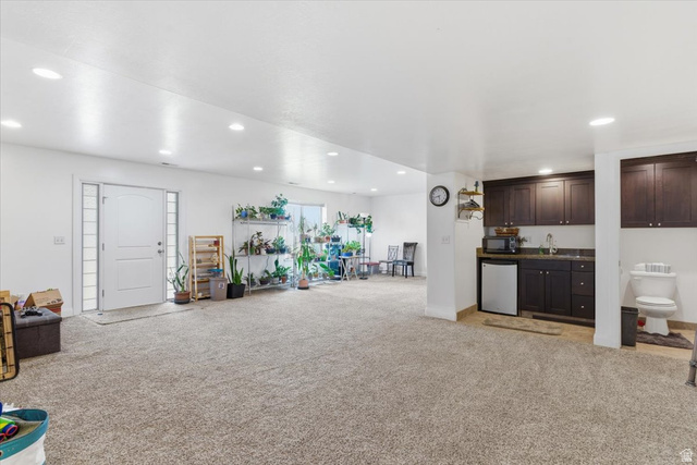 6237 West 4600th Street South Hooper, UT 84315 - Photo 32 of 48 Indoor wet bar with light colored carpet, dark wood finish cabinets, refrigerator, recessed lighting, and dark countertops