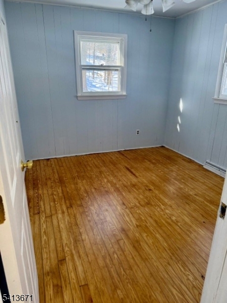 56 Appleseed Road Vernon, NJ 07461 - Photo 4 of 8 an empty room with a wooden floor
