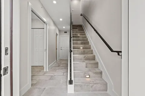 a view of entryway and hall with wooden floor