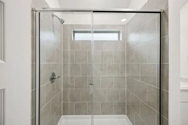 a bathroom with a glass shower door