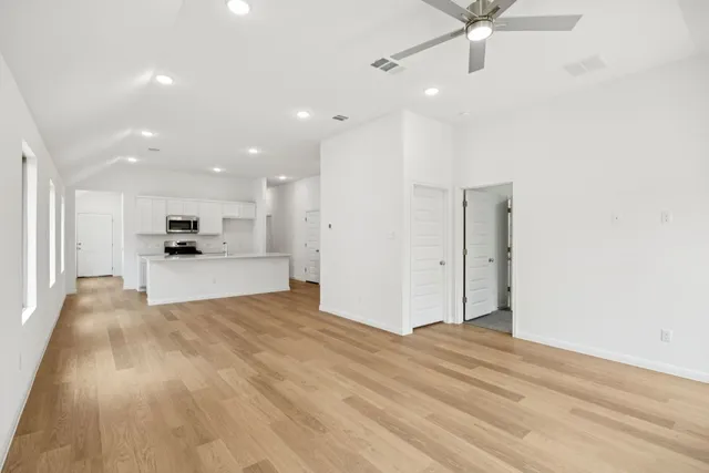 a view of kitchen with kitchen island and stainless steel appliances