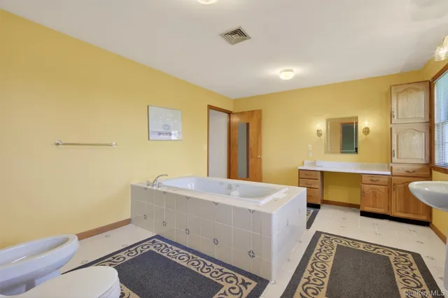 a bathroom with a sink mirror vanity and a toilet