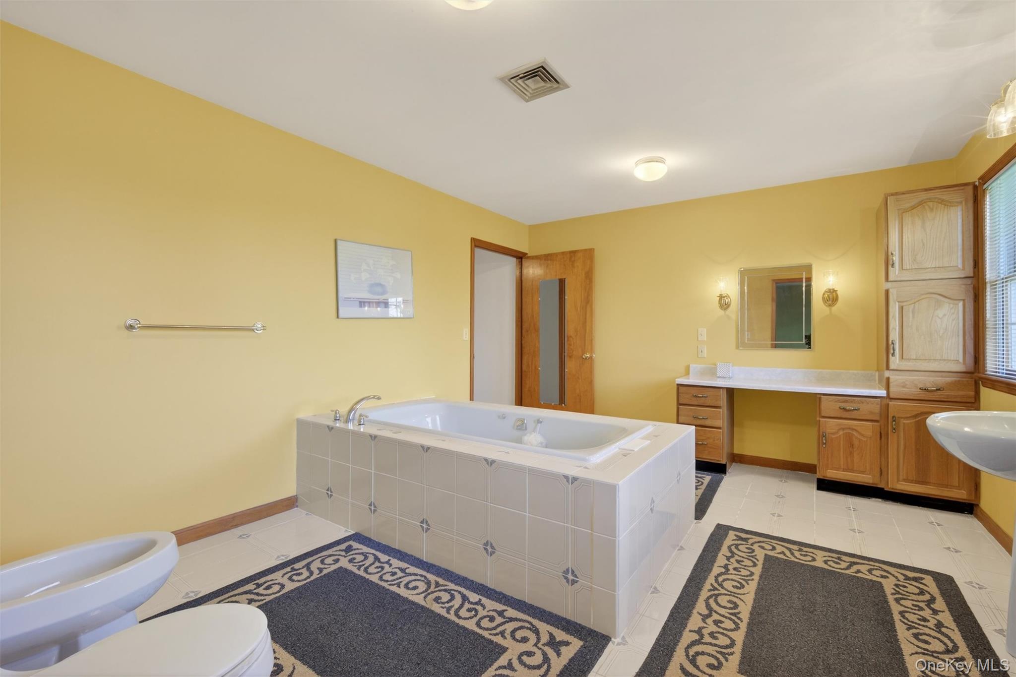 561 Toleman Road Rock Tavern, NY 12575 - Photo 17 of 31 a bathroom with a sink mirror vanity and a toilet