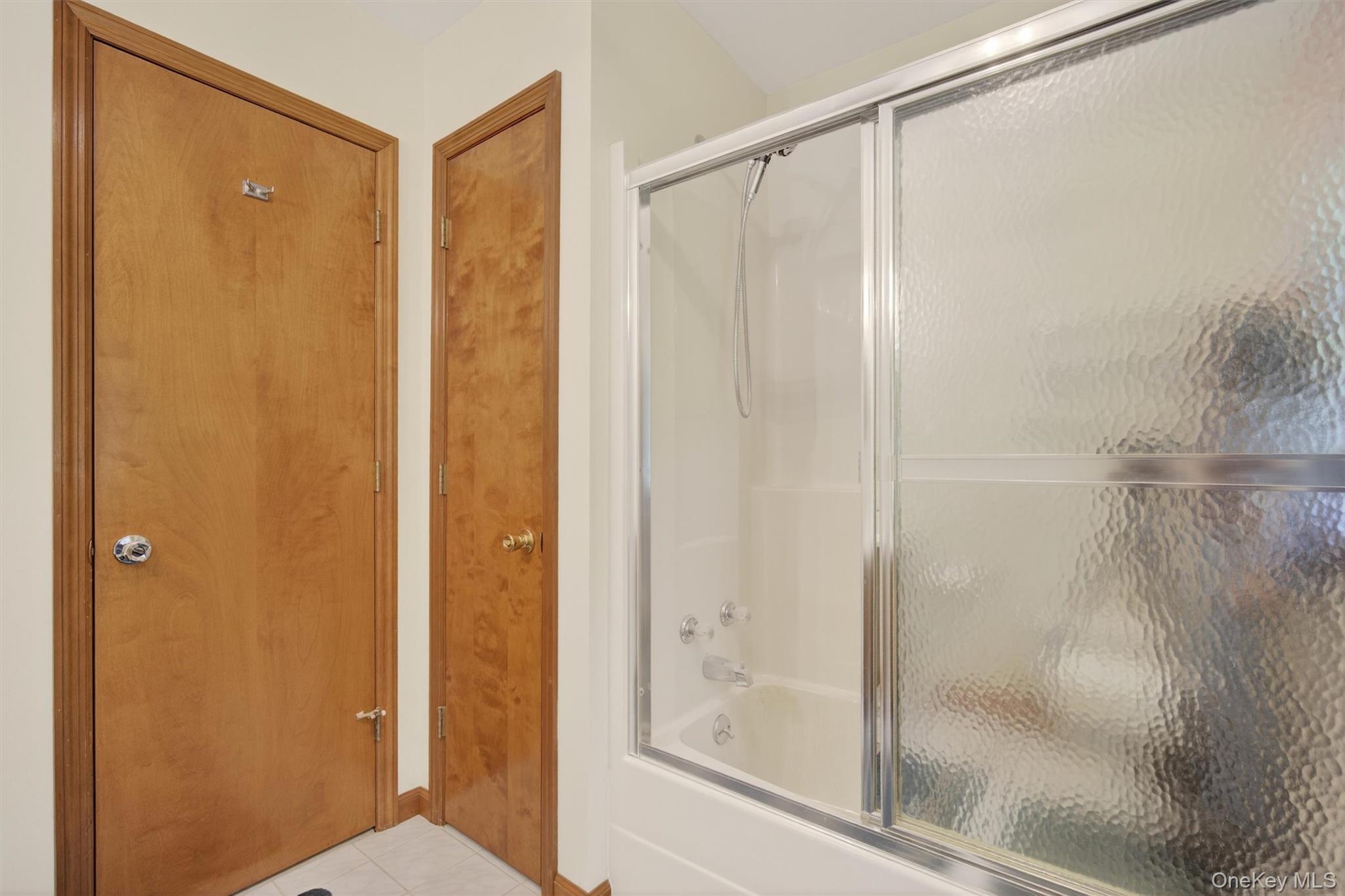 561 Toleman Road Rock Tavern, NY 12575 - Photo 22 of 31 a bathroom with a glass shower door