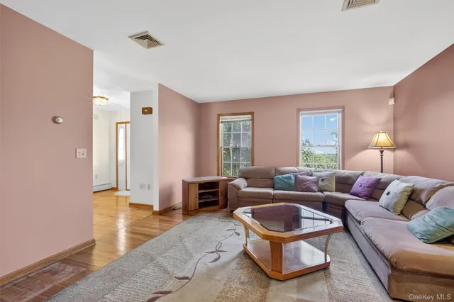a living room with furniture gym equipment and a window