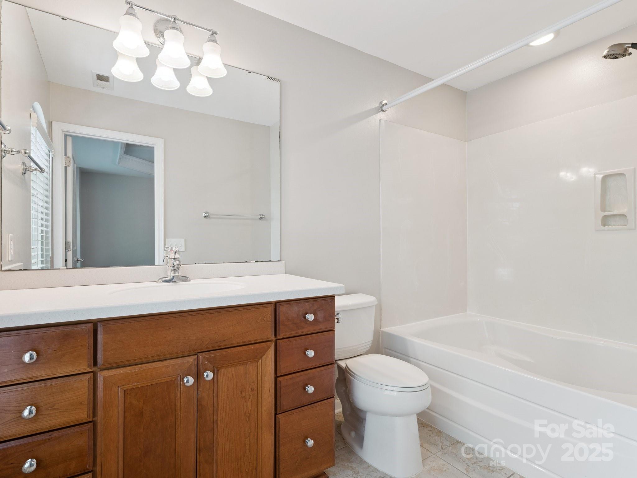 570 6th Baxter Crossing Fort Mill, SC 29708 - Photo 18 of 37 a bathroom with a sink vanity mirror bathtub and toilet