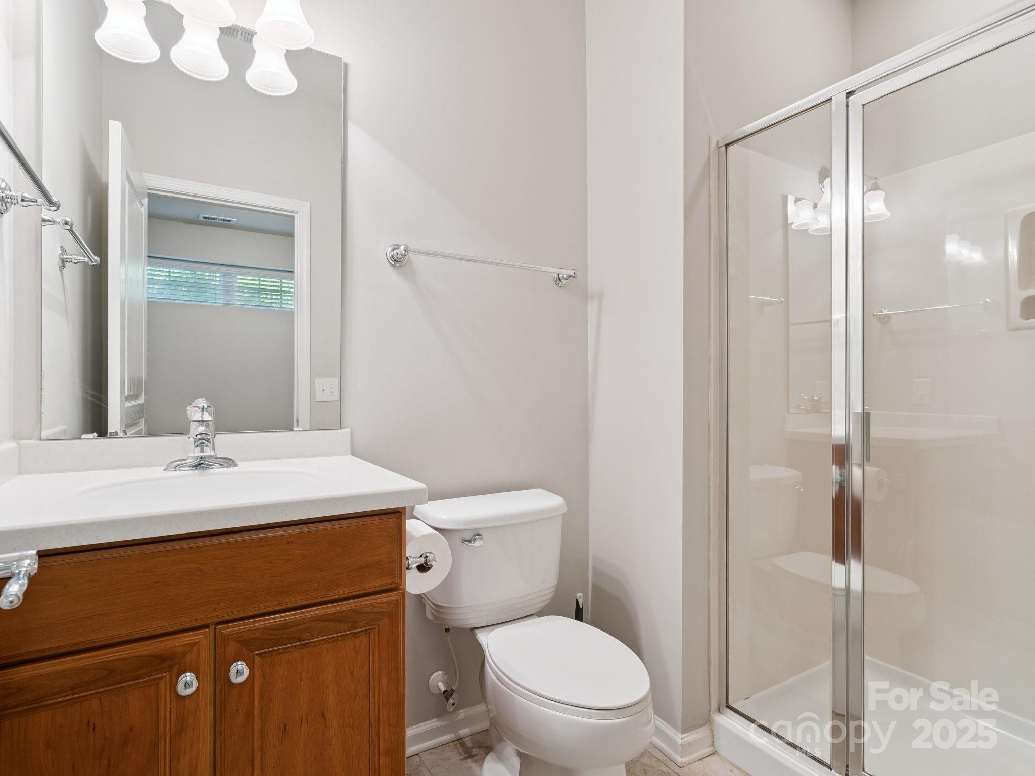 570 6th Baxter Crossing Fort Mill, SC 29708 - Photo 25 of 37 a bathroom with a toilet a sink and a mirror