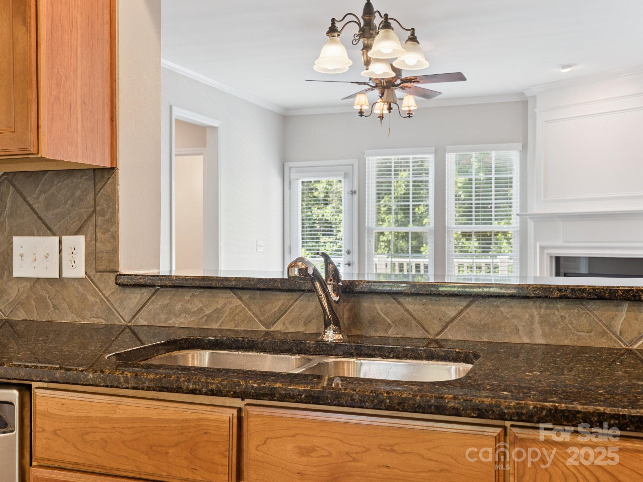 570 6th Baxter Crossing Fort Mill, SC 29708 - Photo 8 of 37 a kitchen with granite countertop a sink and a window