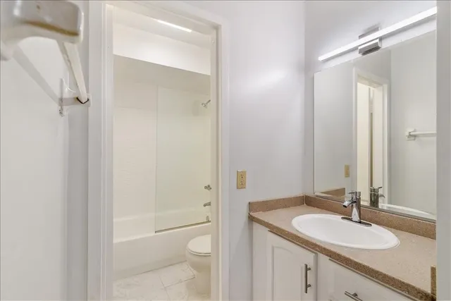 a bathroom with a shower a toilet and a shower