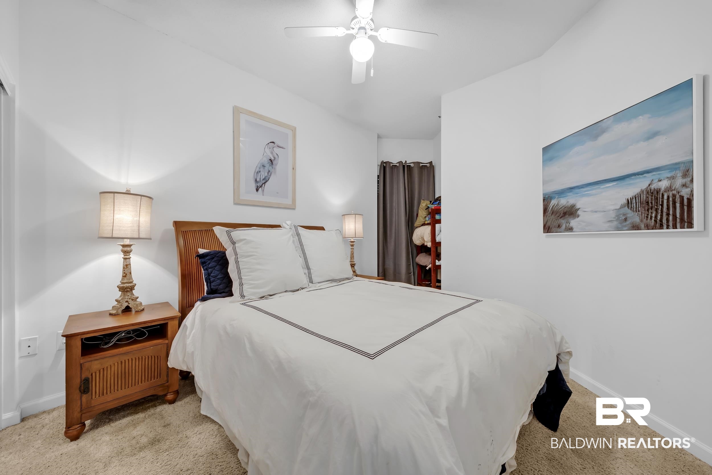 27282 Canal Road, Unit 104 Orange Beach, AL 36561 - Photo 43 of 79 Bedroom with light colored carpet and ceiling fan
