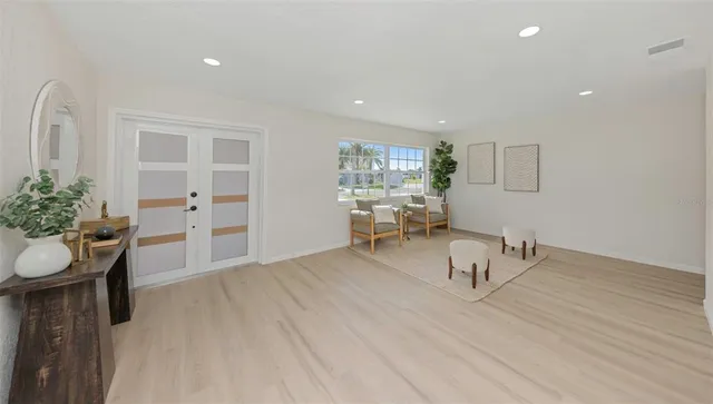 a kitchen with stainless steel appliances a refrigerator stove and white cabinets