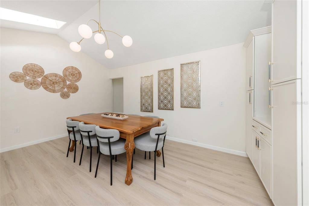 11419 47th Avenue North St. Petersburg, FL 33708 - Photo 19 of 94 a dining room with wooden floor and chandelier