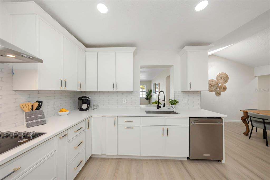 11419 47th Avenue North St. Petersburg, FL 33708 - Photo 29 of 94 a kitchen with white cabinets and appliances
