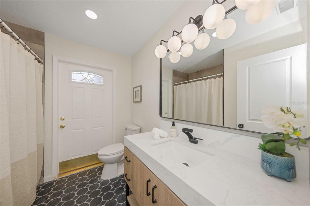 11419 47th Avenue North St. Petersburg, FL 33708 - Photo 34 of 94 a bathroom with a sink a toilet and a mirror