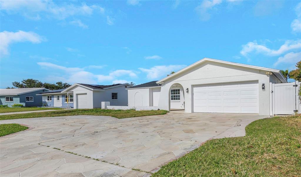 11419 47th Avenue North St. Petersburg, FL 33708 - Photo 4 of 94 a front view of a house with a yard and garage