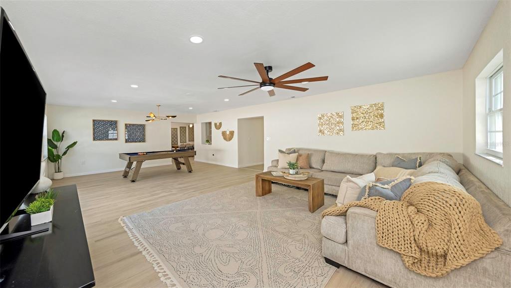 11419 47th Avenue North St. Petersburg, FL 33708 - Photo 49 of 94 a living room with furniture and a flat screen tv