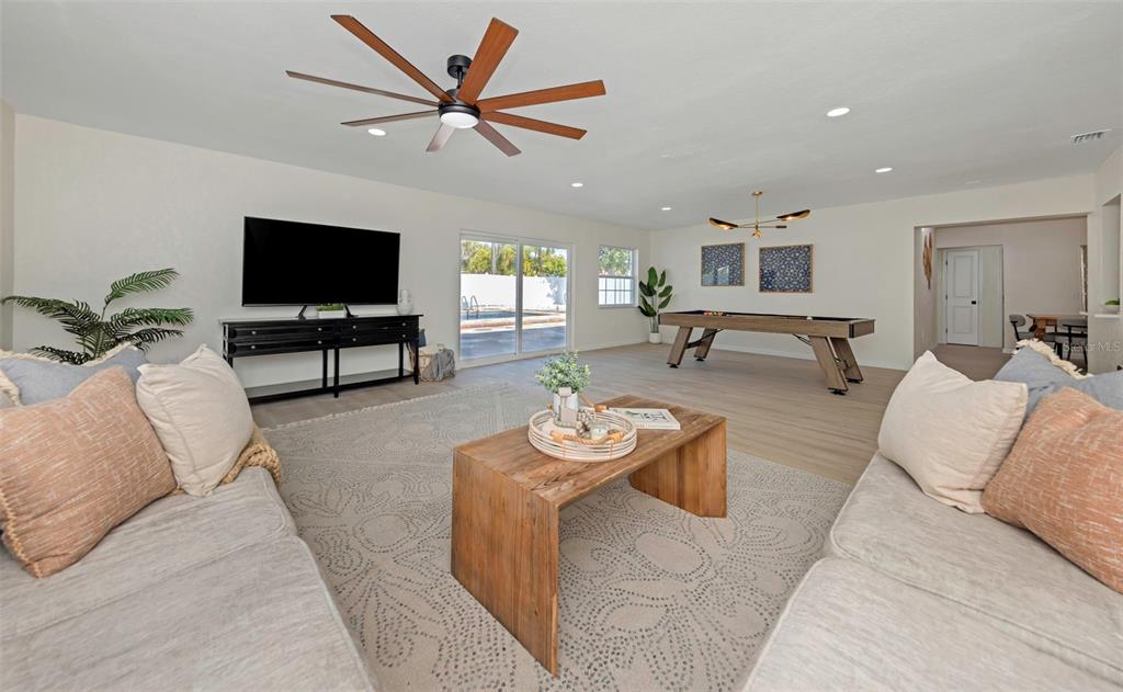 11419 47th Avenue North St. Petersburg, FL 33708 - Photo 50 of 94 a living room with furniture and a flat screen tv