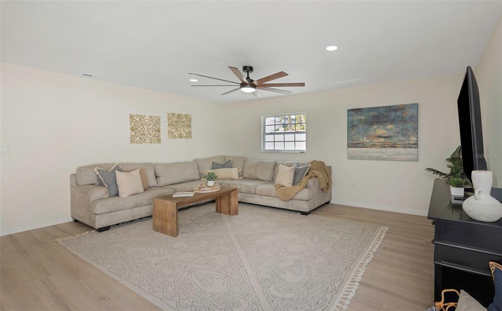 11419 47th Avenue North St. Petersburg, FL 33708 - Photo 53 of 94 a living room with furniture a window and a flat screen tv