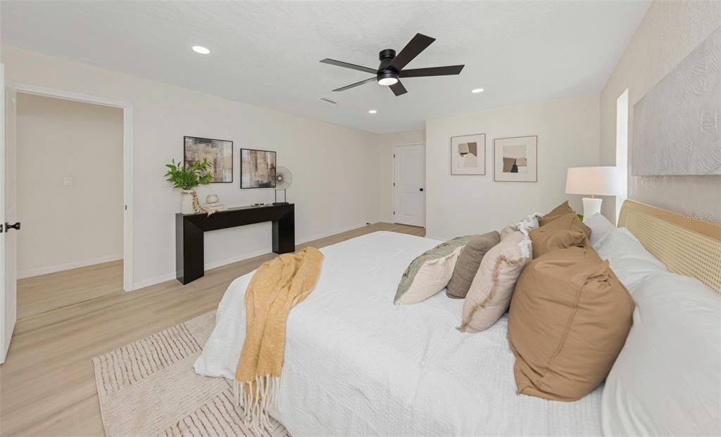 11419 47th Avenue North St. Petersburg, FL 33708 - Photo 55 of 94 a bedroom with a bed and a painting on the wall