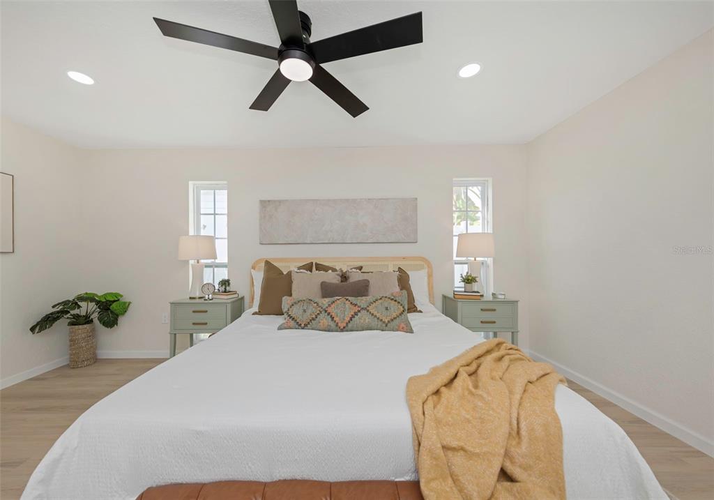 11419 47th Avenue North St. Petersburg, FL 33708 - Photo 56 of 94 a bedroom with a bed and a potted plant