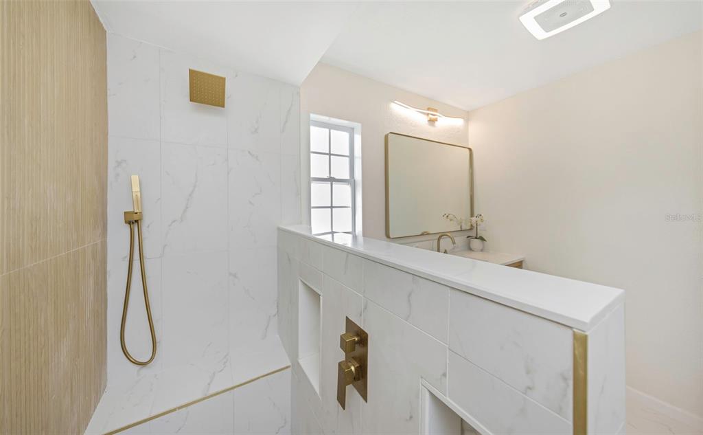 11419 47th Avenue North St. Petersburg, FL 33708 - Photo 61 of 94 a bathroom with a sink and mirror