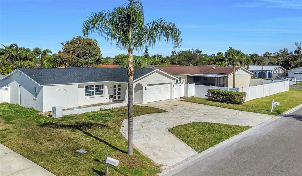 11419 47th Avenue North St. Petersburg, FL 33708 - Photo 72 of 94 a view of a house with a yard and palm trees
